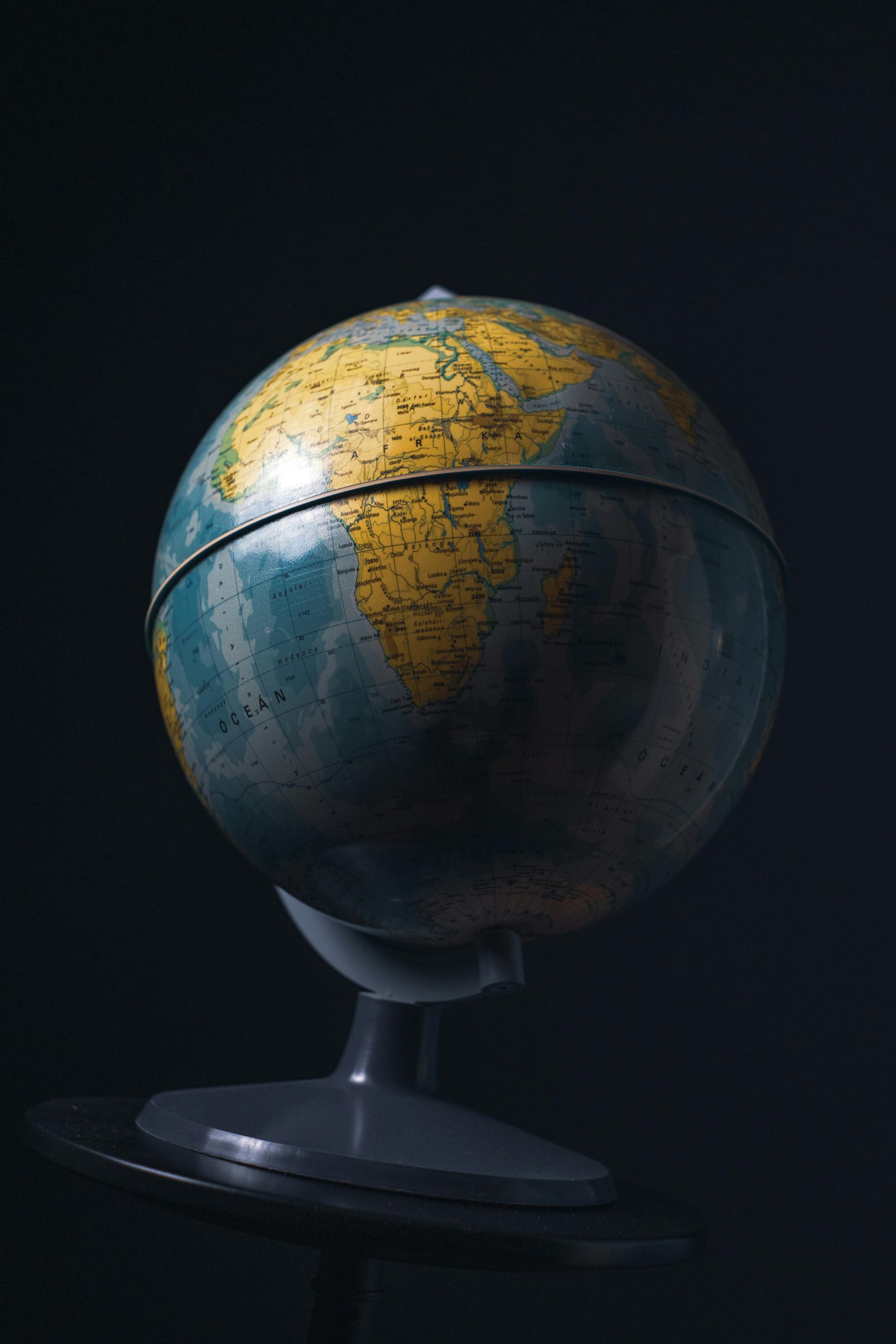 A classic globe with a focus on Africa, set against a dark background for dramatic effect.